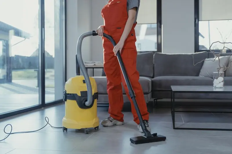 Person vacuuming a floor