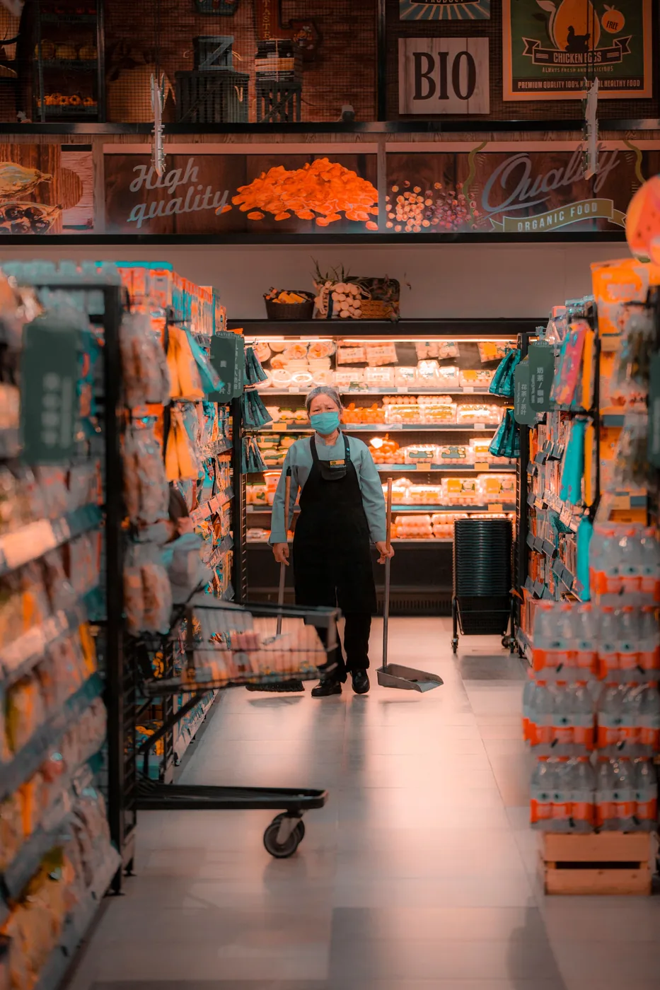 Cleaner mopping the floor of a retail shopping space